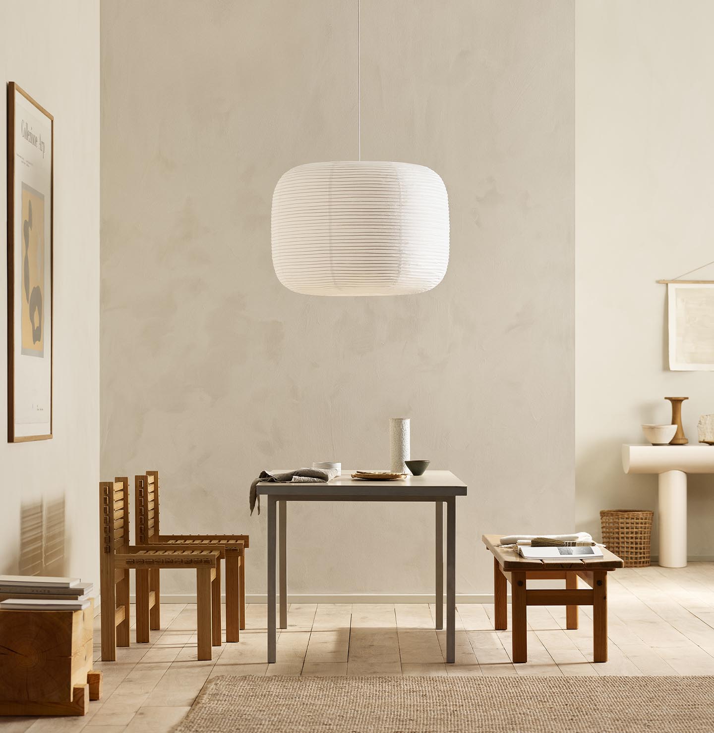 Minimalist dining area with wooden chairs, pendant light, and golden beige walls painted with the colour 12308 Unbleached from Jotun.