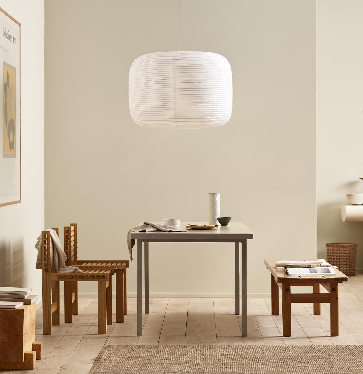 Minimalist dining area with wooden chairs, pendant light, and golden beige walls painted with the colour 12308 Unbleached from Jotun.
