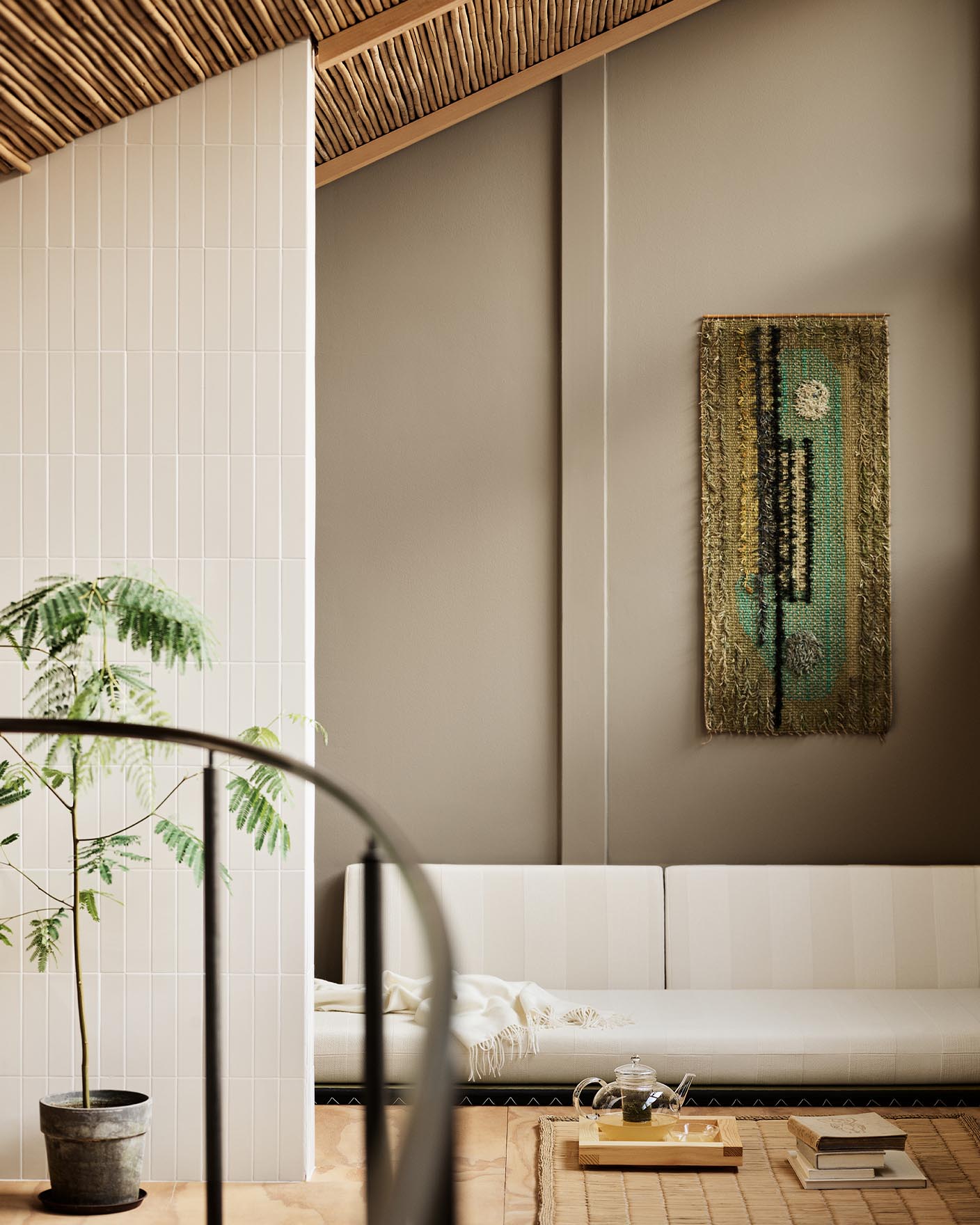 Modern living room with white sofa and abstract wall painting hanging on a golden beige wall painted in the colour 12292 Caramel Brown from Jotun.