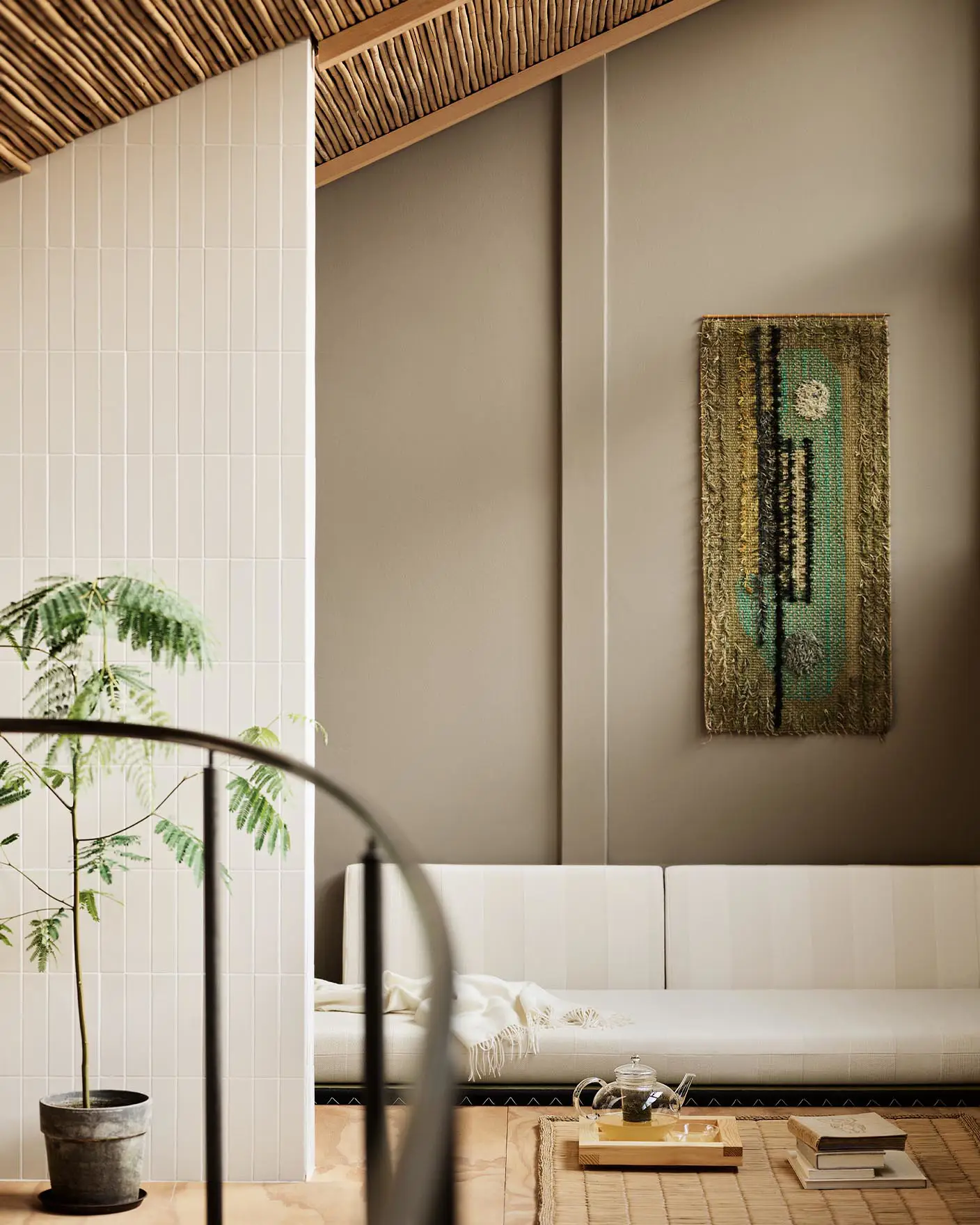 Modern living room with white sofa and abstract wall painting hanging on a golden beige wall painted in the colour 12292 Caramel Brown from Jotun.