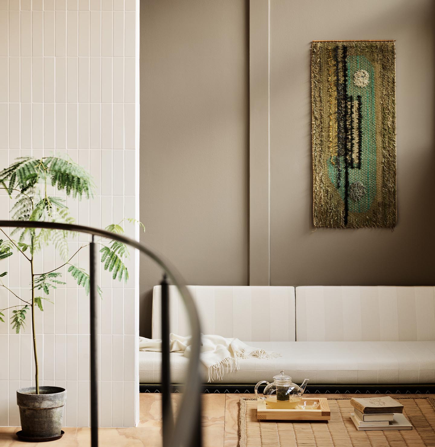 Modern living room with white sofa and abstract wall painting hanging on a golden beige wall painted in the colour 12292 Caramel Brown from Jotun.