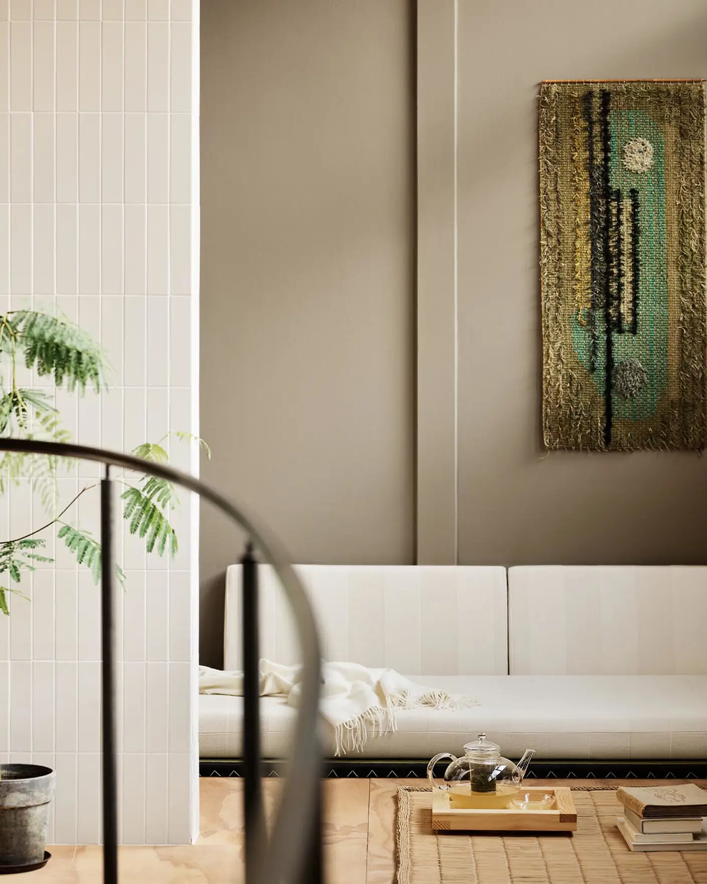 Modern living room with white sofa and abstract wall painting hanging on a golden beige wall painted in the colour 12292 Caramel Brown from Jotun.