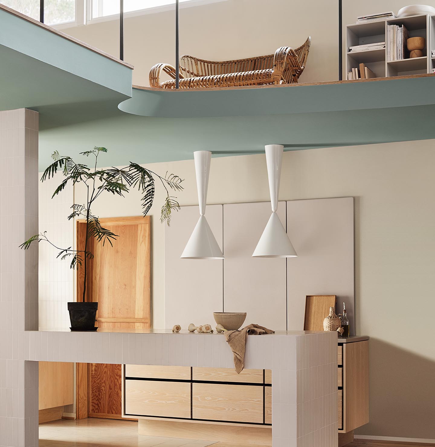 Modern interior with pendant lights and a loft area. Beige walls painted with the Jotun colour 12308 Unbleached. Loft area painted in the bluish green colour 6378 Iconic.