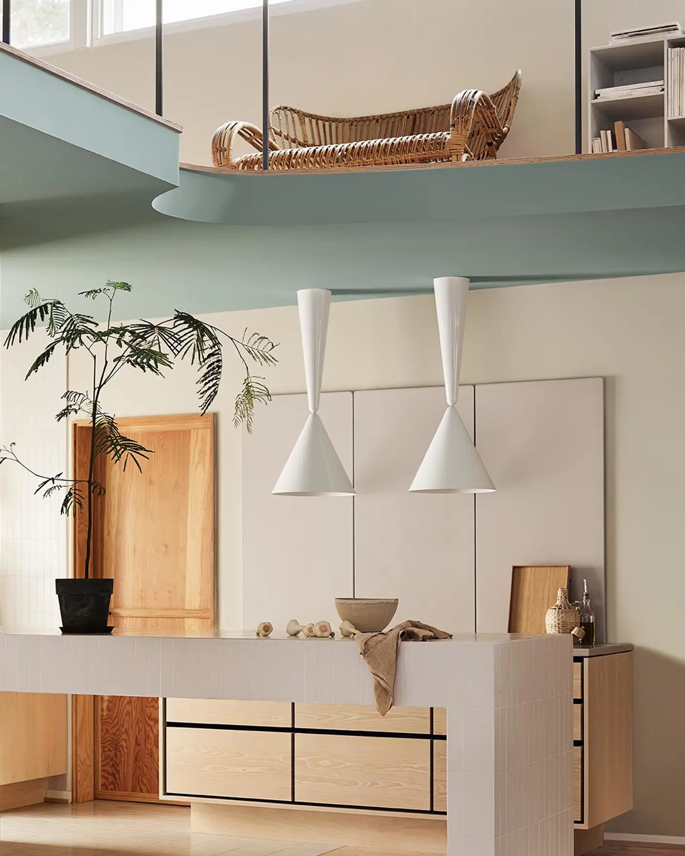 Modern interior with pendant lights and a loft area. Beige walls painted with the Jotun colour 12308 Unbleached. Loft area painted in the bluish green colour 6378 Iconic.