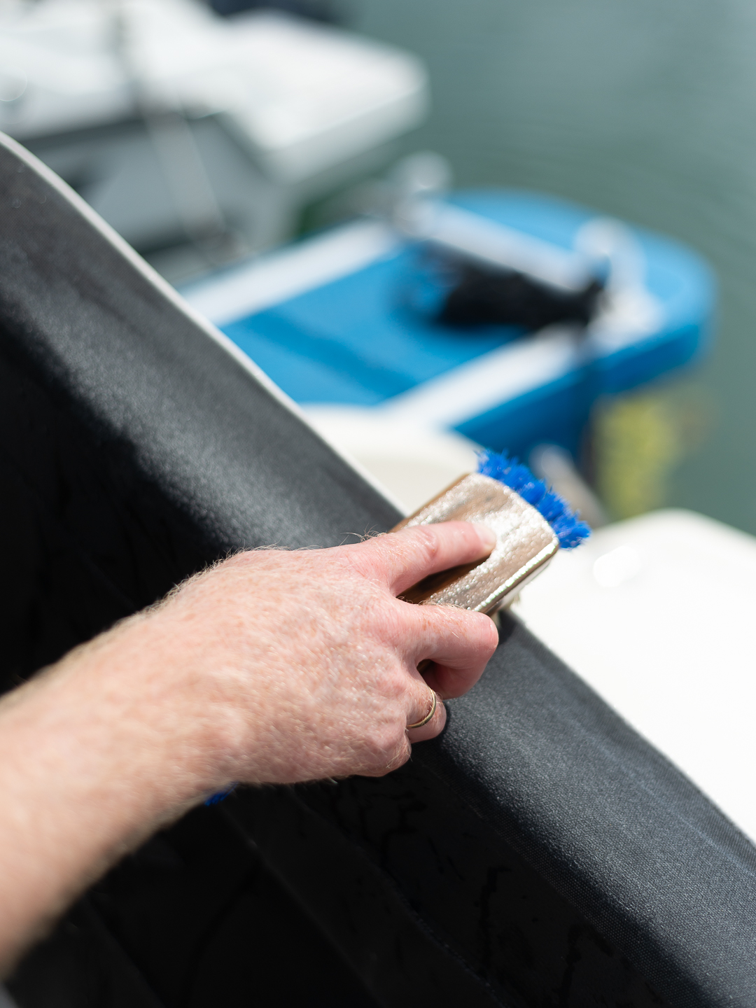 Vasking av båtpute med skrubbebørste.